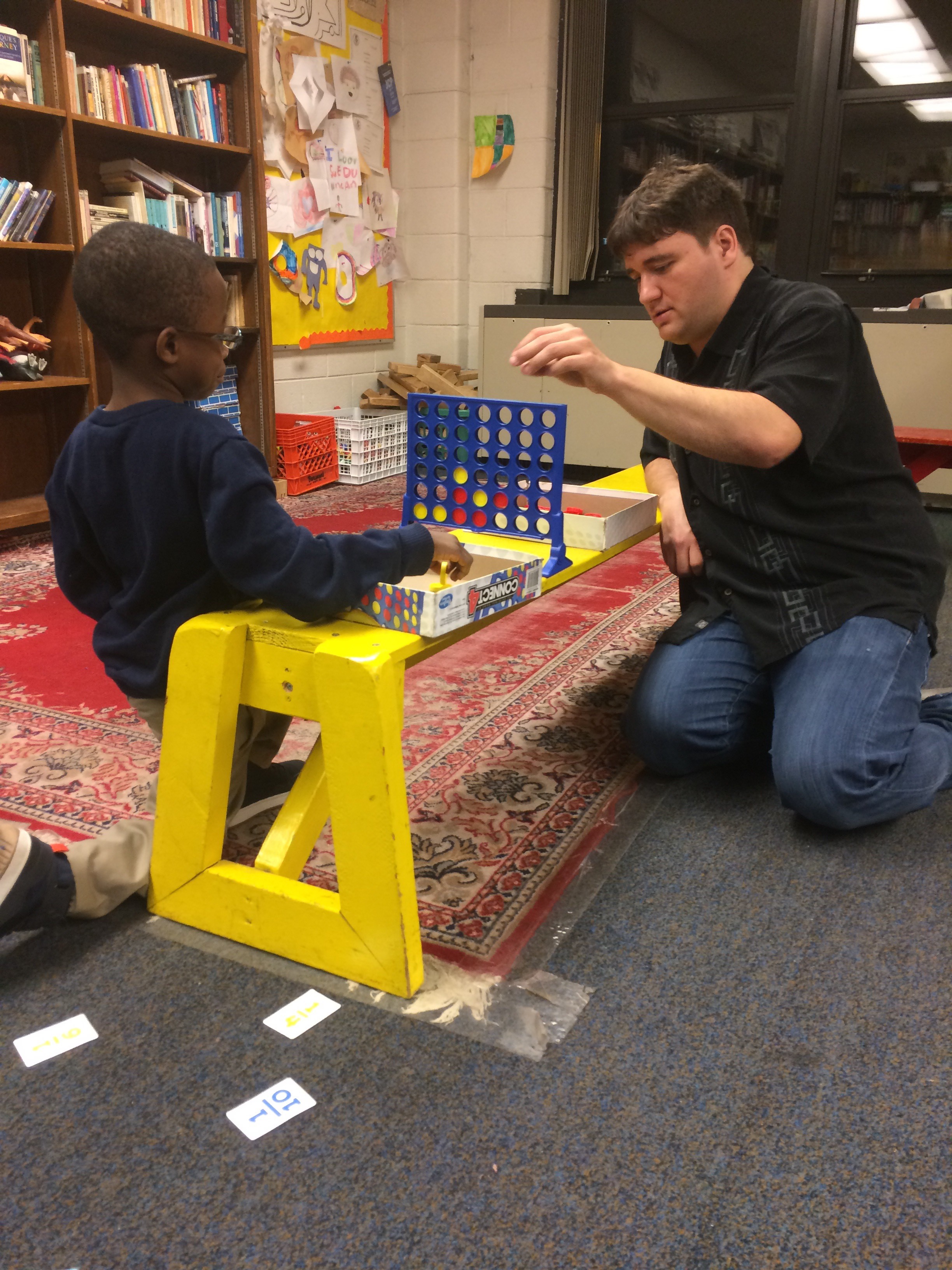  - TCSPP Clinical Psy.D. student palying Connect Four with a student from the Sue Duncan Children Center - December 2017.